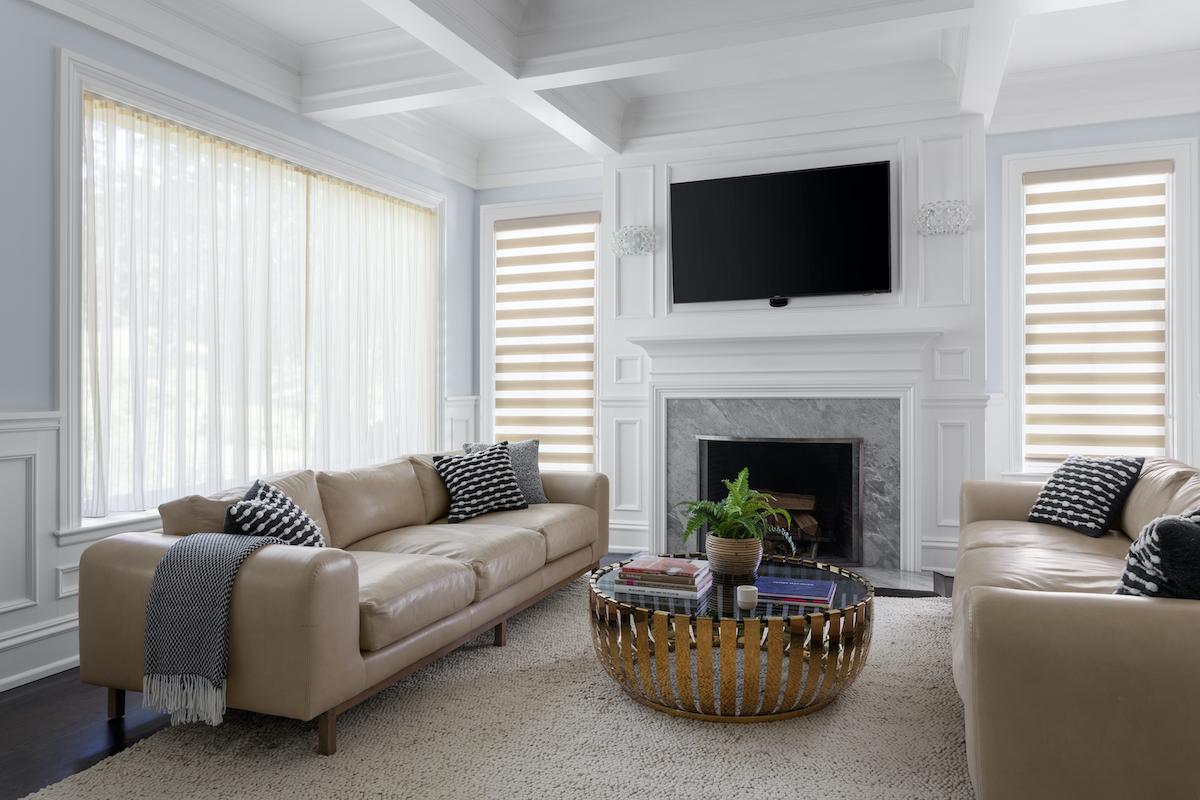 Knowledge Base TV mounted above fireplace with Smart Shades